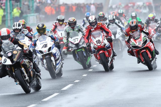 Michael Rutter (Bathams BMW) leads the pack away at the start of a wet opening Superbike race at the 2014 North West 200.