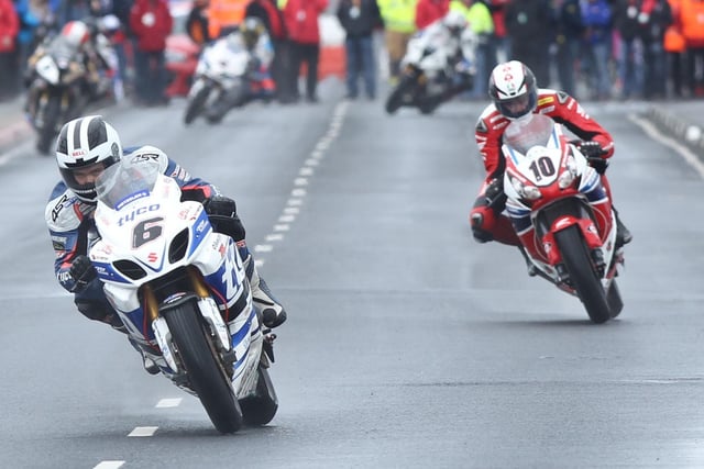 William Dunlop (Tyco Suzuki) leads Conor Cummins (Honda Legends) in the first Superbike race at the North West 200 in 2014.