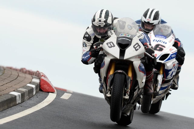 Michael Dunlop (Hawk BMW) took the lead from his brother William (Tyco Suzuki) on the final lap of the first Superbike race at the 2014 North West 200 to set up a mouth-watering finish on the Coast Road.