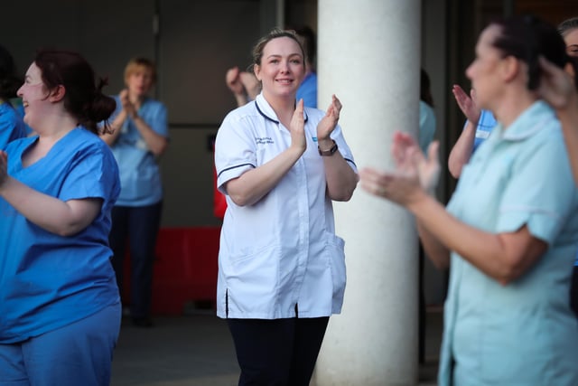 Staff outside Belfast City Hospital's tower block, which is Northern Ireland's first Nightingale Hospital, hold a short event at 8.00pm to recognise and acknowledge the public support during a Clap for Blue Light Services