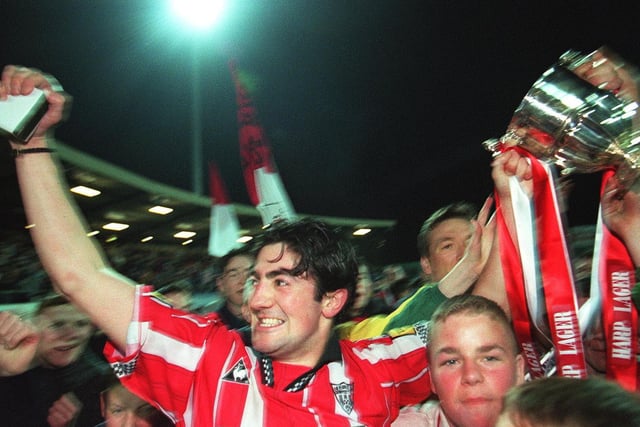 Captain, Peter Hutton and Liam Coyle are mobbed by Derry City fans after winning the title.