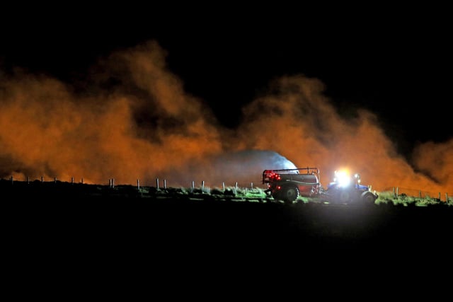 Farmers spray water as a wildfire continues to rage close to the village of Armoy in Co Antrim. Pic Steven McAuley/McAuley Multimedia