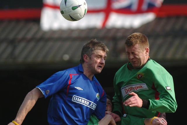 Glentoran's Pat McGibbon wins this aerial battle with Linfield's William Murphy