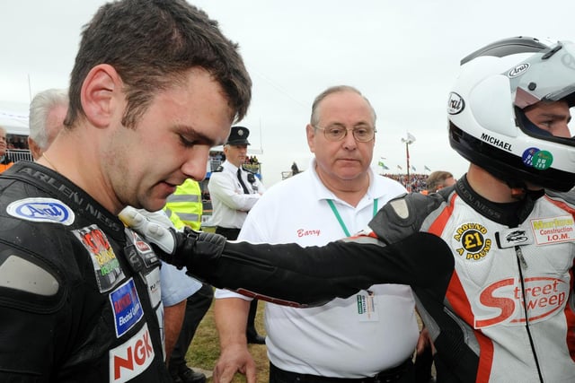 Michael Dunlop consoles his brother William after his Honda developed a problem on the warm-up lap, preventing him from taking part in the 250cc race.