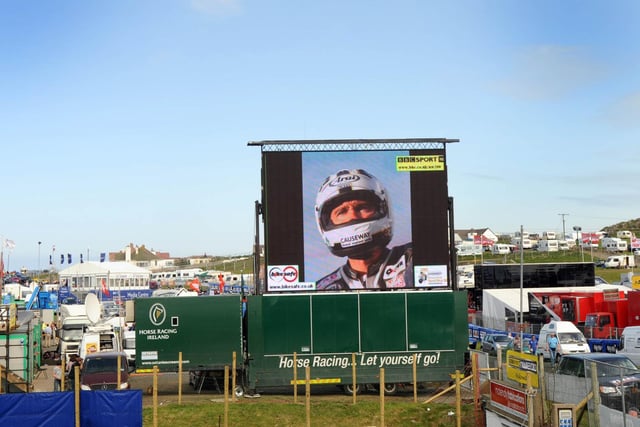 An image of Robert Dunlop displayed on the huge screen in a subdued NW200 paddock following his tragic death.