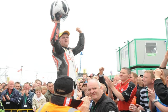 An emotional Michael Dunlop acknowleges the support of the crowd following his victory in the 250cc race.