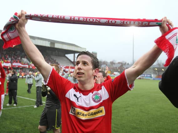 Cliftonville's Eamonn Seydak celebrates winning the Premiership in 2013.