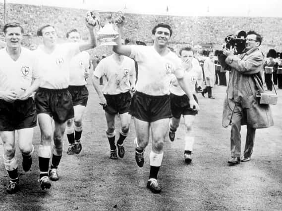 Tottenham Hotspurs right-half captain Danny Blanchflower (left) and centre-forward Bobby Smith celebrate with the FA Cup before the 100,000 crowd