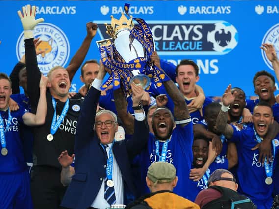 Leicester City captain Wes Morgan and manager Claudio Ranieri lift the trophy as the team celebrate winning the Barclays Premier League