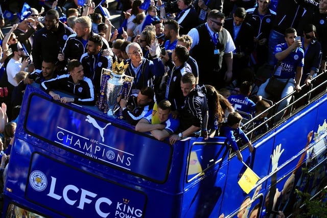 Leicester City manager Claudio Ranieri (centre), Danny Drinkwater (third right), Robert Huth (second right) and Jamie Vardy (right) celebrate with the trophy during the open top bus parade