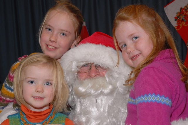 Catherine, Jane and Olivia give Santa a big hug during the 'Breakfast with Santa' held at Bellaghy PS, last Saturday morning.mm4907-149ar.