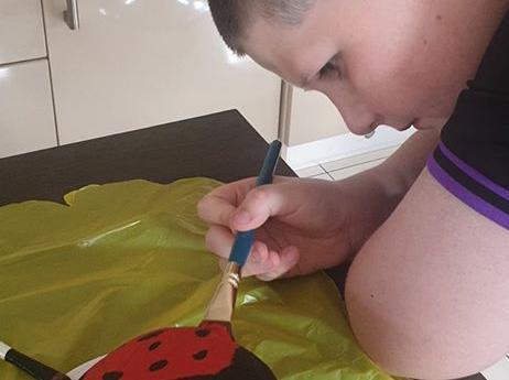 Andrena Boyd: "My wee man adding colour to our garden painting stones".