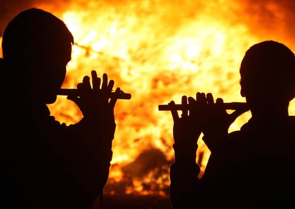 Flutes are played at a bonfire