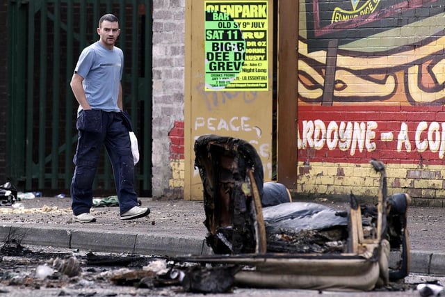 A man (name not known) walks past debris following a night of rioting in Ardoyne in north Belfast
