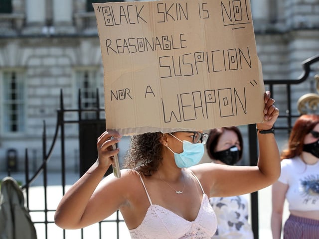 One protester holds her placard aloft during the rally.