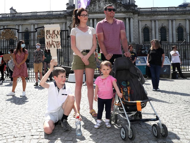 A young family pictured at the rally outside of Belfast City Hall.