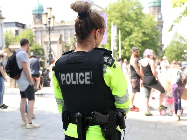 A PSNI officer keeps watch during the rally earlier today.