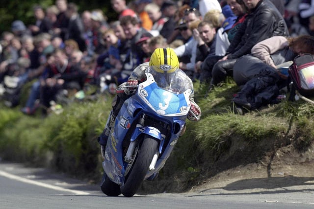 Joey Dunlop exits the Gooseneck in the Junior TT on his way to fourth placeon the 600cc Harris Honda in 2000.