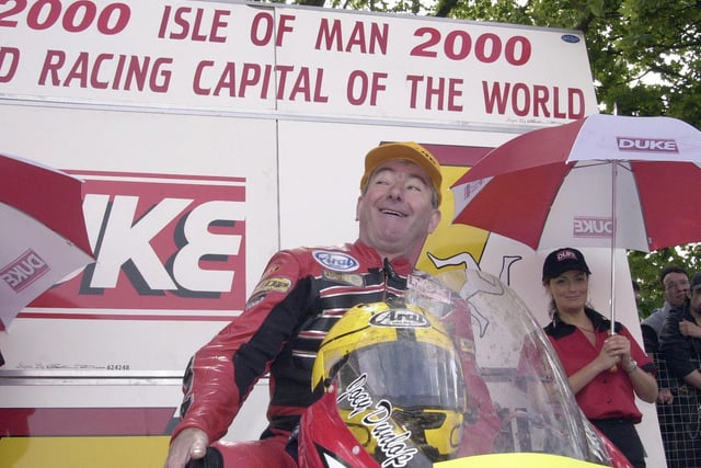 Ballymoney's Joey Dunlop cracks a wry smile in the winners' enclosure at the 2000 Isle of Man TT after he was asked if he was 'too old' to get onto his bike.