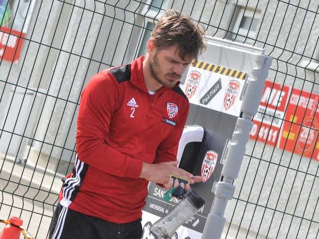 Derry City defender, Colm Horgan gets himself ready for training after using the sanitising station at Aileach.