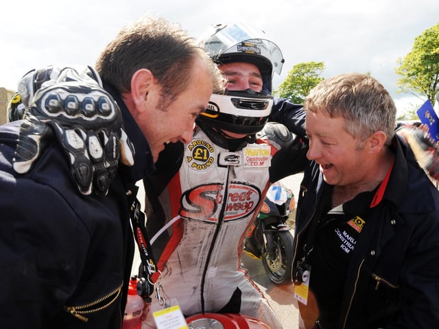 A jubilant Michael Dunlop celebrates his first TT success with sponsors Gary Ryan (left) and Martin Marlow.