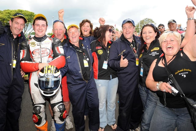 Supersport race winner Michael Dunlop celebrates his first TT victory with all his team in 2009.