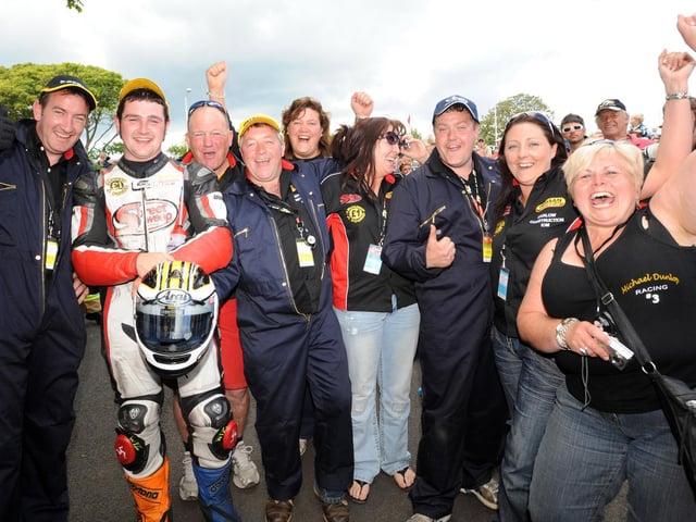 Supersport race winner Michael Dunlop celebrates his first TT victory with all his team in 2009.