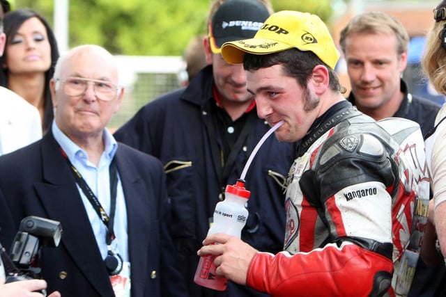 Michael Dunlop in the winner's enclosure with legendary Formula One race commentator Murray Walker after winning his first TT race in 2009.