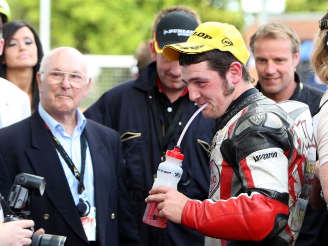 Michael Dunlop in the winner's enclosure with legendary Formula One race commentator Murray Walker after winning his first TT race in 2009.