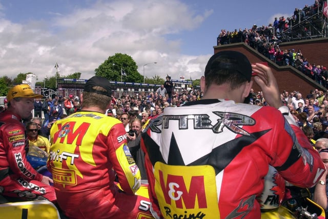 The top three in the 2000 Senior TT are cheered by the huge crowds at the Grandstand.