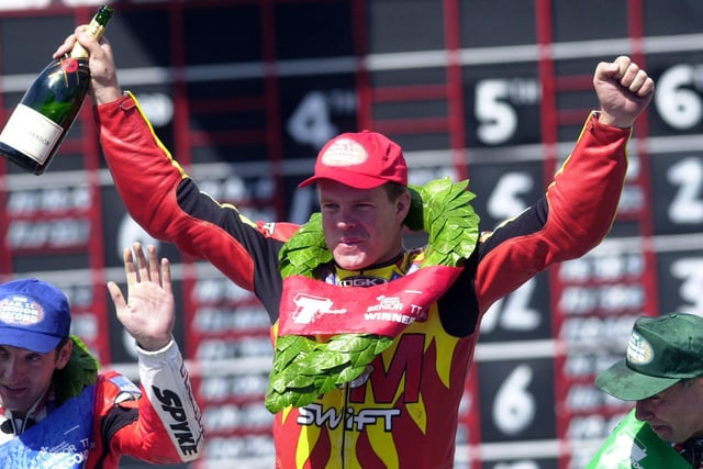 David Jefferies celebrates his Senior victory and the first 125mph lap at the Isle of Man TT with runner-up Michael Rutter (left) and Joey Dunlop.