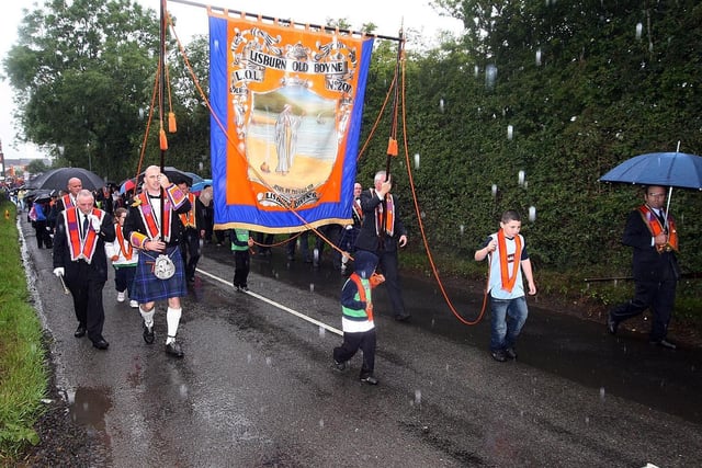 The Lisburn Old Boyne LOL 207 make their way through a rainsoaked Maghaberry on the Twelfth. US2907-150AO  Picture By Aidan O'Reilly