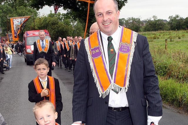 Lisburn Mayor James Tynsley pictured with his son James Junior marching in Maghaberry on the Twelfth.