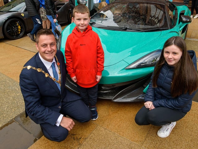 Kyle McFaul with the Mayor Graham Ware and his daughter Caitlin during Super Car Sunday in aid of the Mayorâ€TMs Charity Appeal for Foyle Down Syndrome Trust. Picture Martin McKeown. 03.10.21