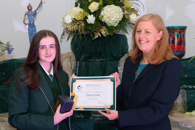 Kayleigh Campbell receives the GCSE Subject Award for Health & Social Care, Mathematics, Science (Double Award) and Design and Technology from Martine Mulhern, Principal of St Cecilia’s College, at the KS4 Awards presentation on Thursday afternoon last in the school. DER2141GS – 035