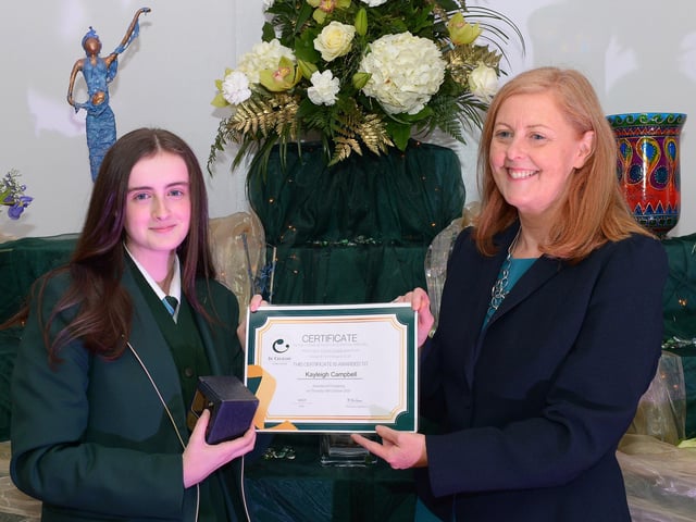 Kayleigh Campbell receives the GCSE Subject Award for Health & Social Care, Mathematics, Science (Double Award) and Design and Technology from Martine Mulhern, Principal of St Cecilia’s College, at the KS4 Awards presentation on Thursday afternoon last in the school. DER2141GS – 035