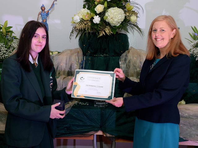 Jodi Montgomery receives the Courage Commitment Award from Martine Mulhern, Principal of St Cecilia’s College, at the KS4 Awards presentation on Thursday afternoon last in the school. DER2141GS – 030