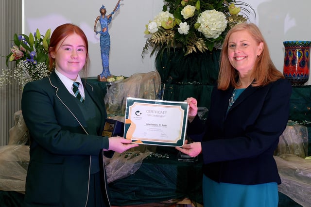 Aine Moore receives the Faith Commitment Award from Martine Mulhern, Principal of St Cecilia’s College, at the KS4 Awards presentation on Thursday afternoon last in the school. DER2141GS – 031