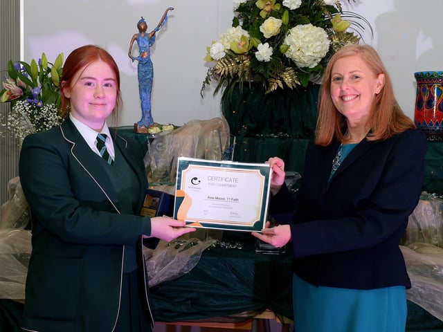 Aine Moore receives the Faith Commitment Award from Martine Mulhern, Principal of St Cecilia’s College, at the KS4 Awards presentation on Thursday afternoon last in the school. DER2141GS – 031