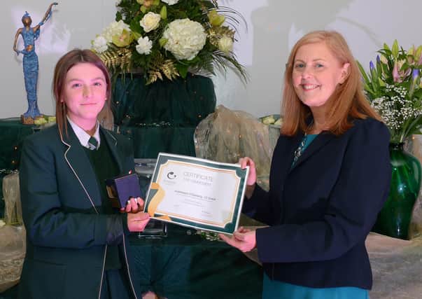 Aiobheann O’Doherty receives the Grace Commitment Award from Martine Mulhern, Principal of St Cecilia’s College, at the KS4 Awards presentation on Thursday afternoon last in the school. DER2141GS – 032
