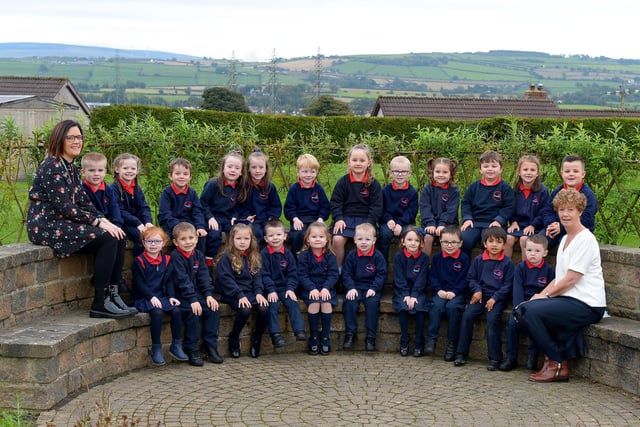 Mrs McKinney (on the left) teacher and Mrs Downey, classroom assistant, pictured with their P 1 class at St Oliver Plunkett Primary School. DER2141GS – 016
