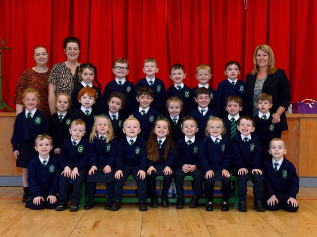 Mrs Quinn (on the right), teacher, and Miss McGowan and Miss Walsh, classroom assistants, with their P1 class at St Patrick’s Primary School. DER2140GS – 022