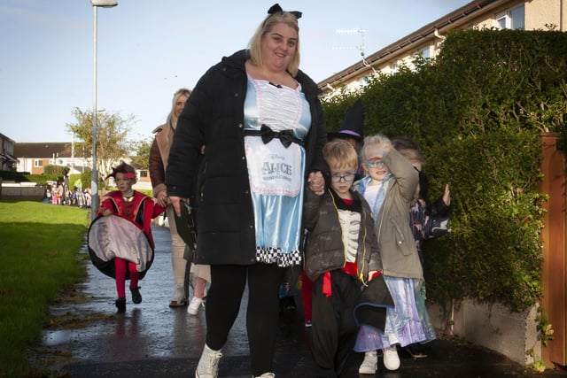 Classroom Assistant Miss Feeney with some of the P2s from Greenhaw PS doing a tour of Carnhill Estate in their Halloween costumes on Friday. (Photos: Jim McCafferty Photography)