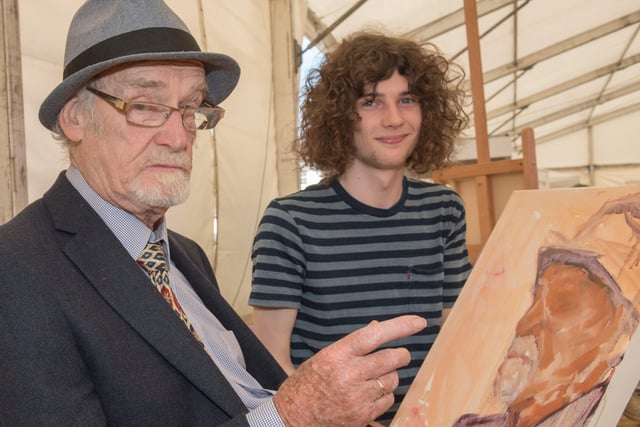 North West Regional College Art student Liam Bradley paints local musician Gay McIntyre at the E2E festival held in Ebrington Square. (Picture by Martin McKeown).
