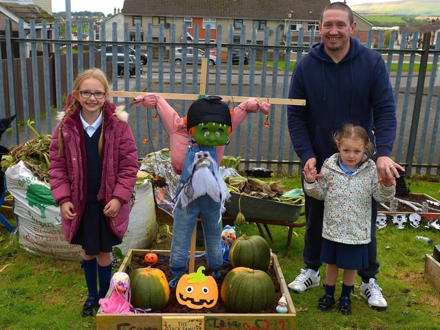 Bunscoil Cholmcille pupils Freya and Leia pictured with their dad Chris at the judging of the school’s Halloween plant beds competition on Monday afternoon last. DER2143GS – 035