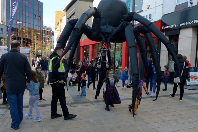 Arachnobot, the giant spider, roams the city centre on Friday afternoon. Photo: George Sweeney.  DER2143GS – 097