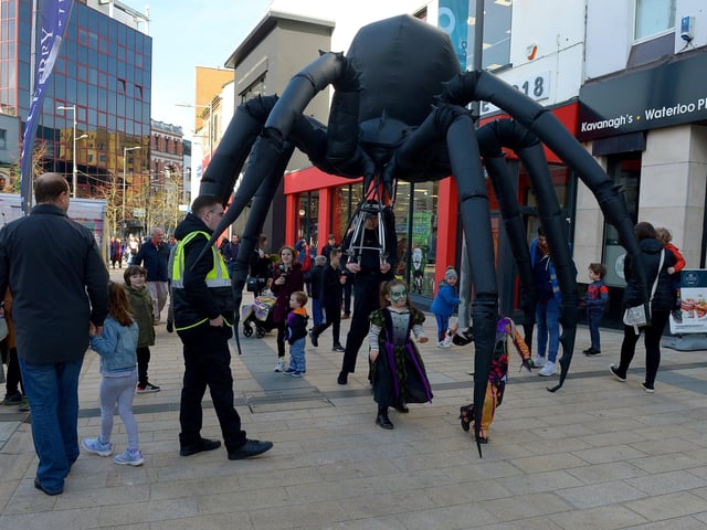 Arachnobot, the giant spider, roams the city centre on Friday afternoon. Photo: George Sweeney.  DER2143GS – 097
