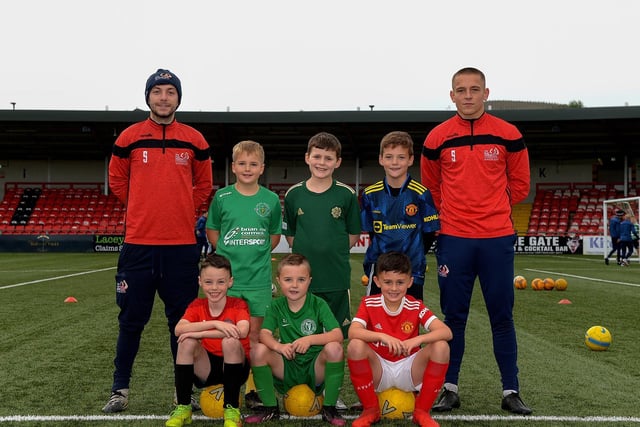 Coaches Paul McLaughlin and Jack Malone pictured with young footballers at the recent Ryan McBride Halloween Camp held at Brandywell Stadium.