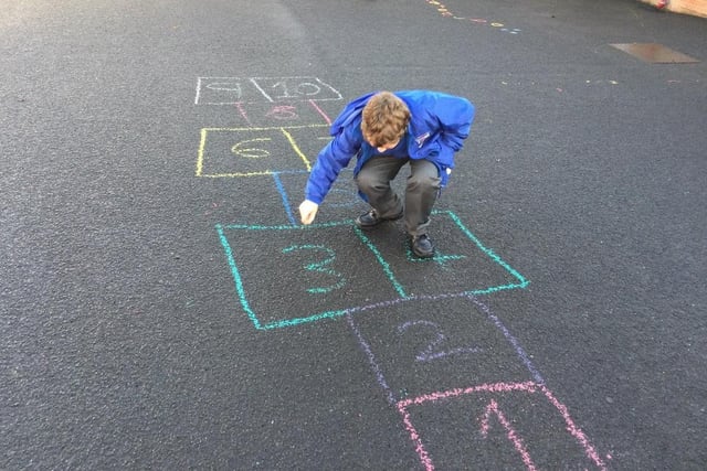 Preparing a game of hopscotch at Macosquin Primary School as part of the Heritage Games organized by Causeway Coast and Glens Borough Council