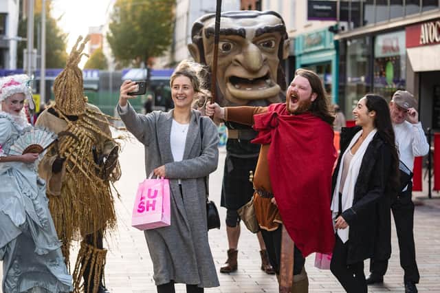 Passers- by have their pictures taken with the Giant Spirit Characters as they move through the city centre.